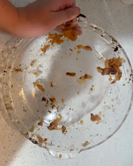 Glass dish with caked-on food residue, before CleanSpin